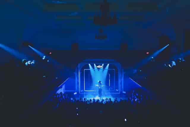 Geometric stage at The Great Hall with dramatic downlighting for keynote event and live music.