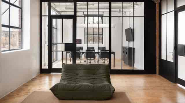 Modern Office Suite with glass boardroom and lounge for corporate meetings and networking.