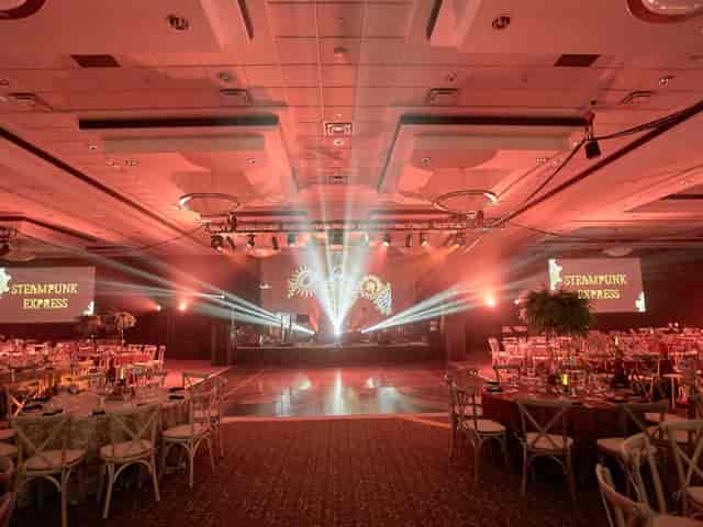 Steampunk Express gala at International Centre with red lighting and custom stage design.
