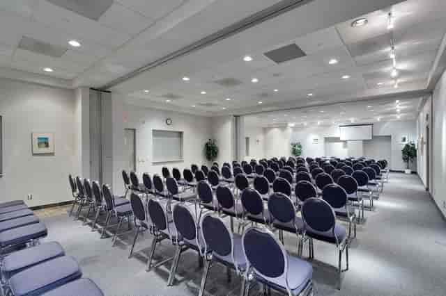 Theater-style conference room with modular partitions for corporate events and presentations.