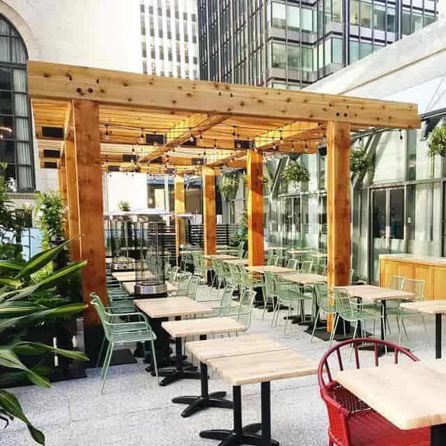 Terrace at Village Loft with bistro lighting and cafe seating for outdoor events and mixers.