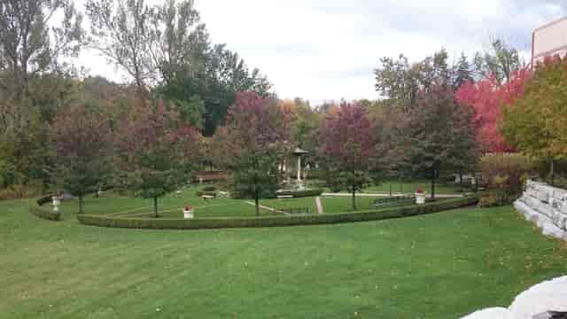 Outdoor wedding ceremony at Ascot Parc Event Centre with elegant landscaping.