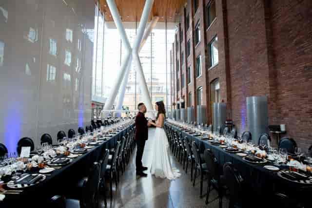 Ricarda's industrial event venue with long table seating for weddings and corporate gatherings.
