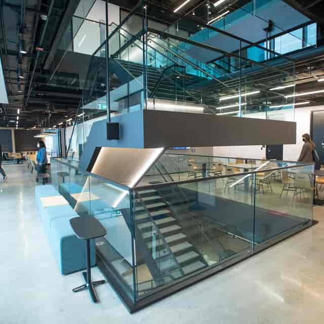 Modern CIBC SQUARE workspace with open staircase for collaborative coworking and team networking.