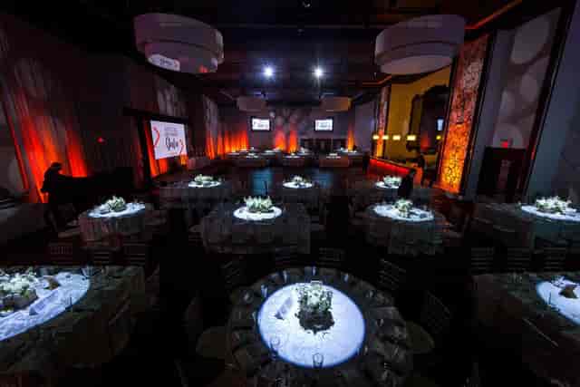 Grand Luxe gala ballroom with dramatic uplighting for banquet and wedding event hosting.