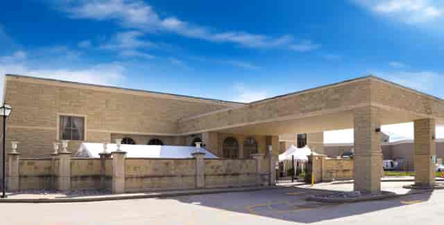 Chateau Le Jardin West Wing exterior with porte-cochère for event and wedding venue rentals.