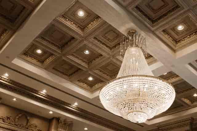 West Wing ballroom at Chateau Le Jardin with crystal chandelier for elegant galas and dinners.