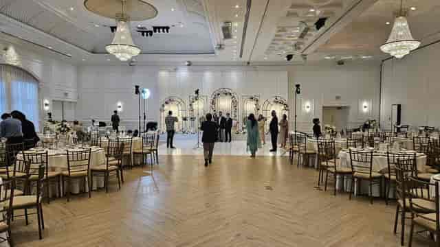 Chateau Le Jardin ballroom with herringbone floors set for a formal gala or wedding reception.