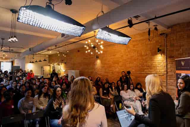 Fireside chat panel in industrial studio with professional lighting for corporate events.