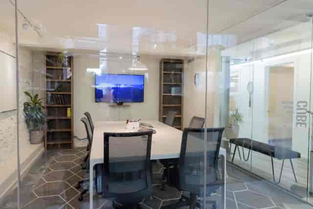 Modern glass breakout room at StartWell for strategy sessions and hybrid meetings.