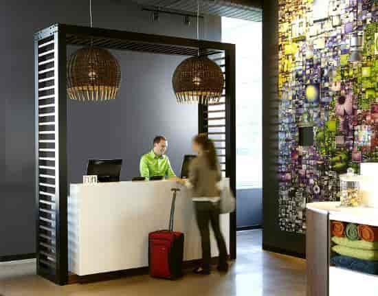 Modern purple reception desk at Alt Hotel Toronto Airport for efficient event delegate check-in.