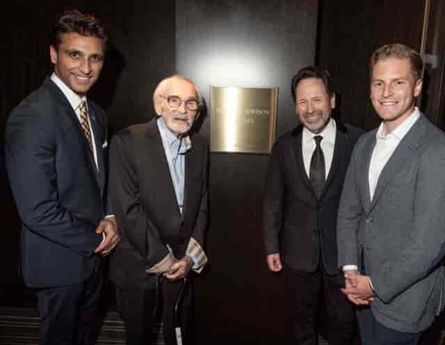 Formal reception photo-op at Norman Jewison Cinema, Toronto, featuring branded corporate event setup.