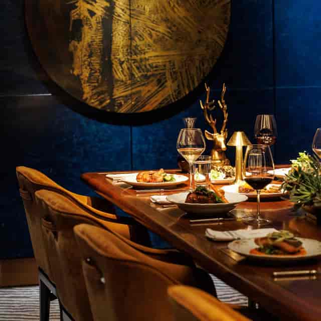 Intimate private dining room with moody lighting for executive dinners and VIP client events.