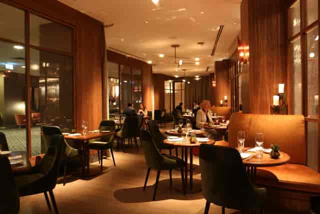Upscale private dining room with velvet seating for premium networking and corporate events.