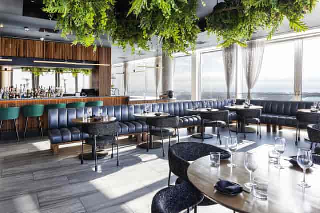 High-end rooftop restaurant with biophilic design for corporate mixers and VIP events.
