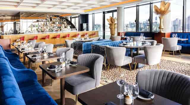 Sophisticated cocktail bar in Valerie with velvet seating for corporate events and networking.
