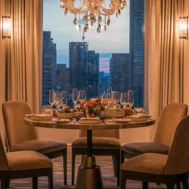 Private dining room at LOUIX LOUIS with city skyline view for luxury corporate events.