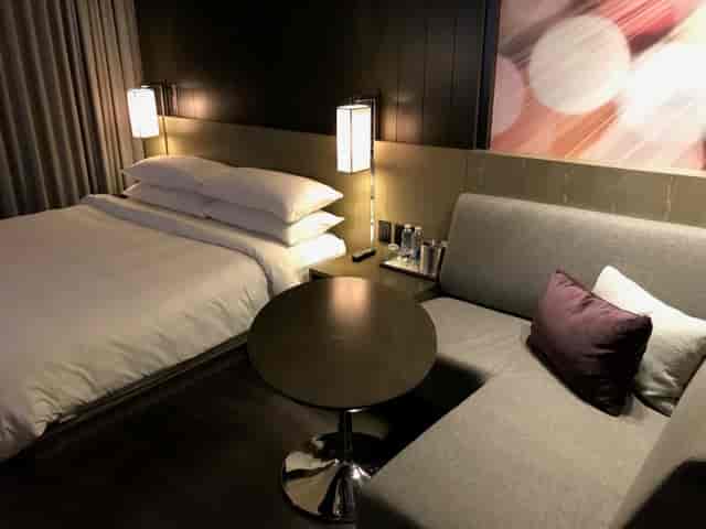 Modern Rouge Room hotel guest room with dedicated workspace for business travel and events.