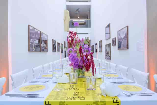 Minimalist banquet at The Power Plant with bold floral decor for high-end corporate event.