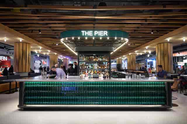 Branded bar at corporate reception, well-lit networking focal point for event activation.