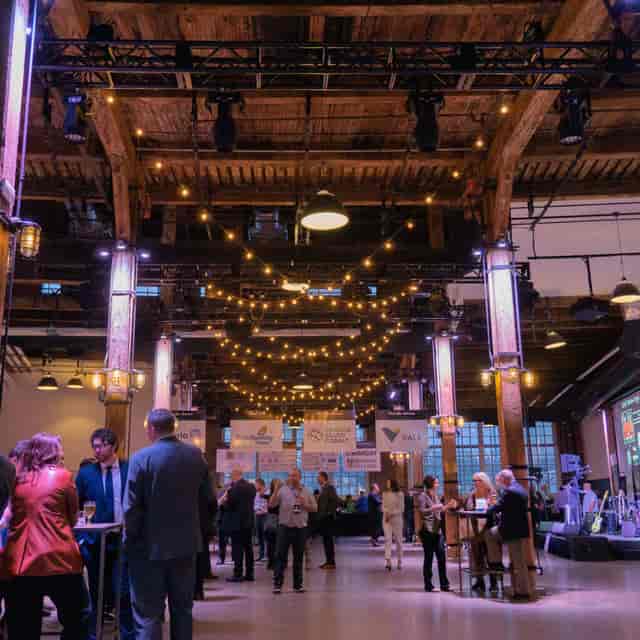 Steam Whistle Roundhouse networking reception featuring industrial-chic venue and string lighting.