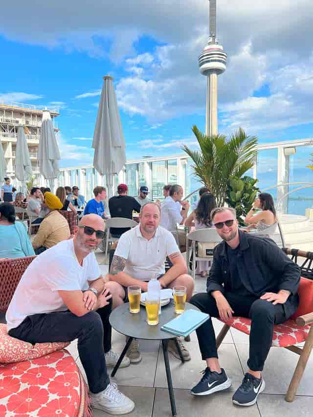 Rooftop networking event at a luxury lounge suite with open-air terrace seating.