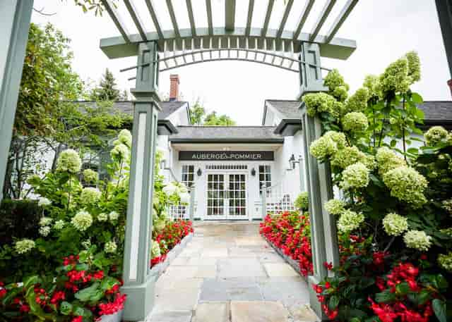 Auberge du Pommier courtyard entrance for boutique weddings and corporate retreats.