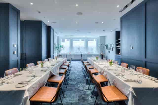 Private dining room with navy millwork for corporate meetings or gala events.