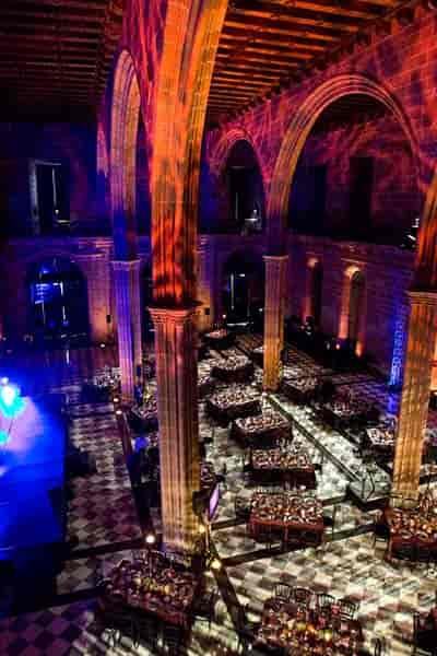 Gala dinner at La Llotja de Mar: historic hall with dramatic architectural lighting and seating.