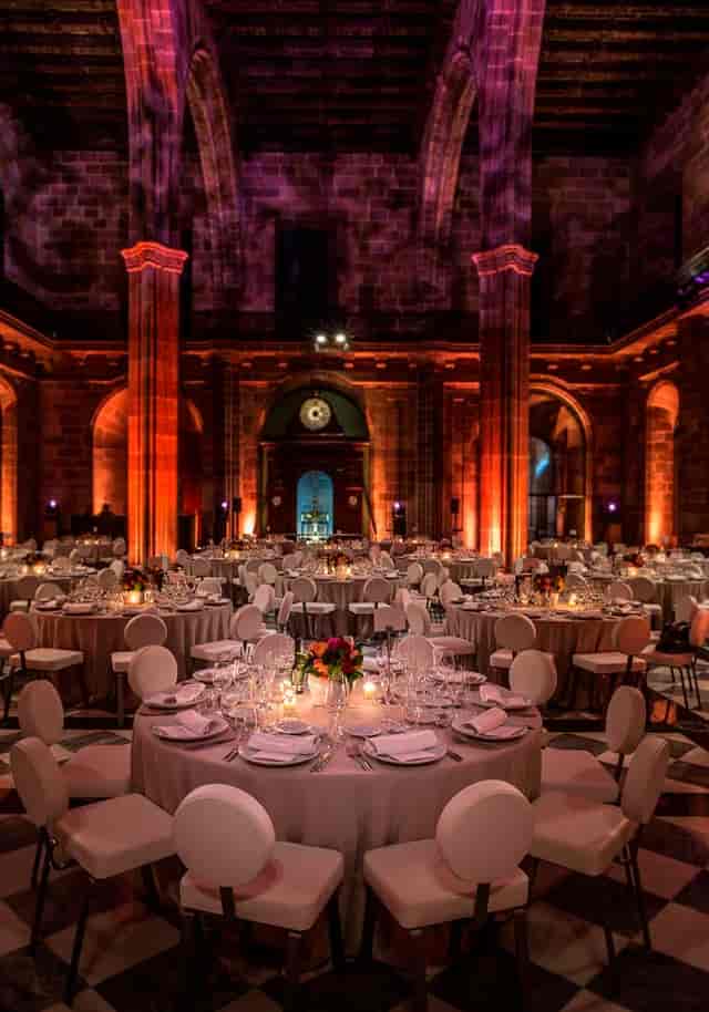 Gala dinner setup at La Llotja de Mar Contracting Hall with dramatic uplighting for corporate events.