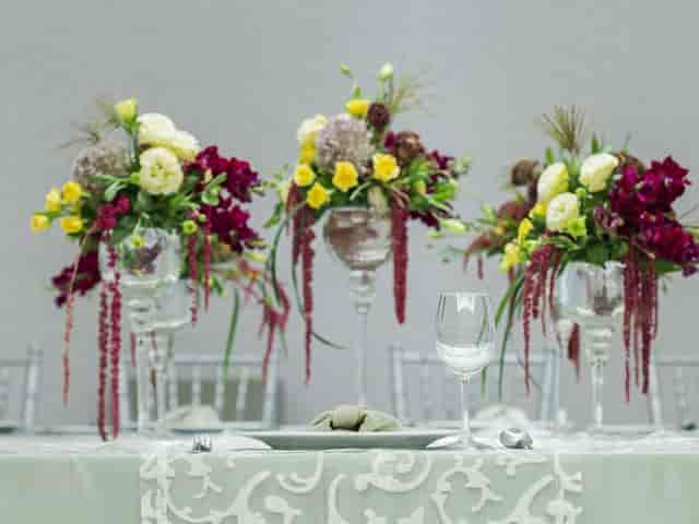 High-end table setting with floral centerpieces for luxury corporate events and gala banquets.