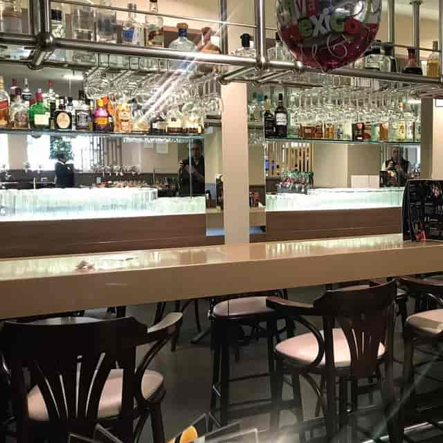 Staged hotel bar with glassware for corporate networking events and conference receptions.