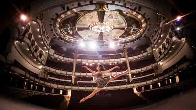 Teatro de la Ciudad historic venue with dramatic stage lighting for keynote or gala events.