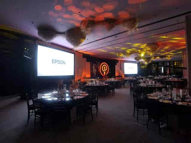 Potentia Club St. Regis corporate gala with ambient lighting, table setup, and AV presentation.