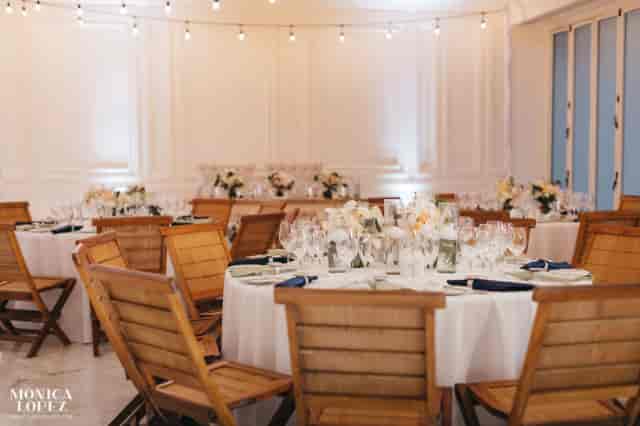 Elegant banquet setup in Grand Velas Riviera Maya ballroom with rustic chairs for wedding events.