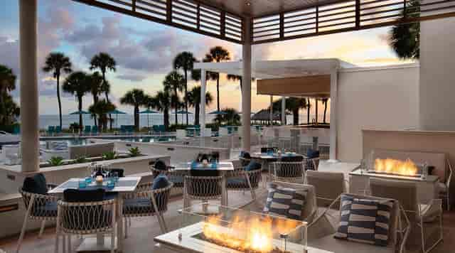 Beachfront sunset reception venue at The Resort at Longboat Key Club with fire pits.