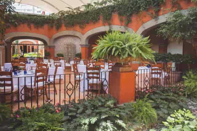 Hacienda de los Morales semi-outdoor venue with tiered dining for garden weddings and events.