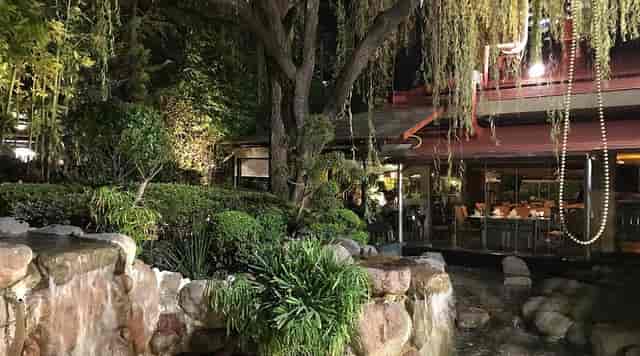 Upscale restaurant with lush landscaping and water features for private dining and networking events.