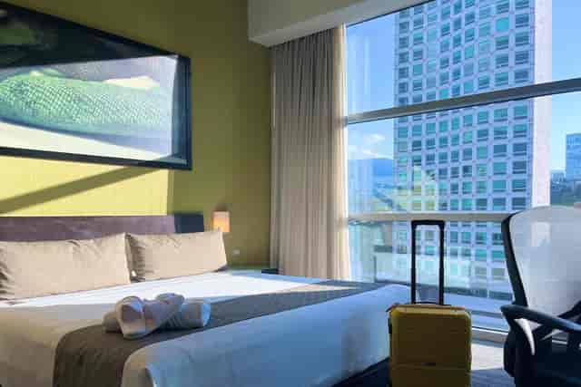 Modern hotel room with city views at Stadia Suites Mexico City for business travel and conventions.