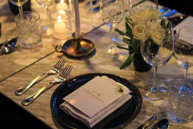 Upscale corporate dinner table setting with marble surfaces for boutique private events.