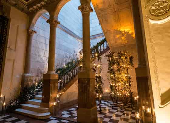 Candle-lit floral installations at Palacio Metropolitano, luxury gala and wedding venue arrival.