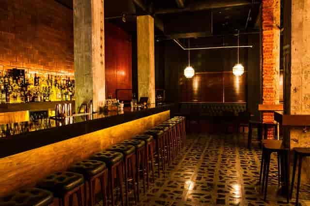Industrial-chic jazz club with exposed brick, ideal for VIP networking and cocktail events.