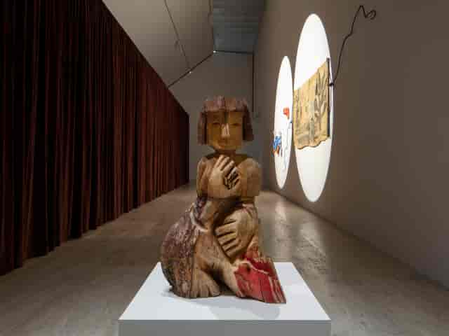 High-end gallery space with dramatic lighting for intimate cocktail reception and art events.