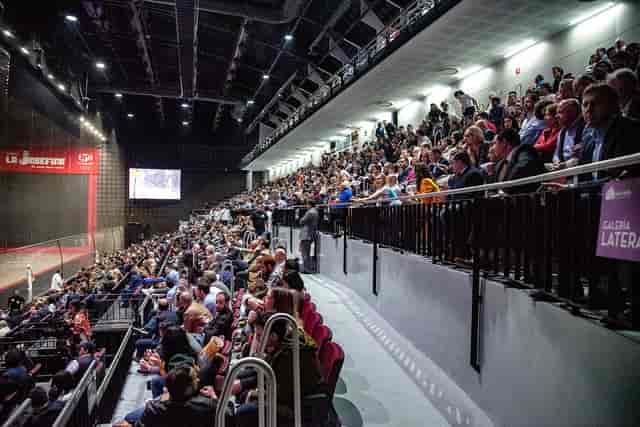 Tiered stadium seating at Frontón México concert hall for large-scale corporate event or sports.