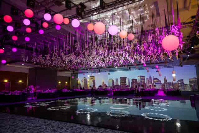 Gala at Centro Banamex featuring custom dance floor, floral installations, and LED event backdrop.