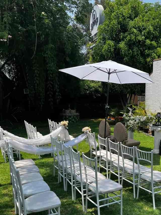 Outdoor wedding ceremony with draped Chiavari chairs at La Quinta Imperial venue.