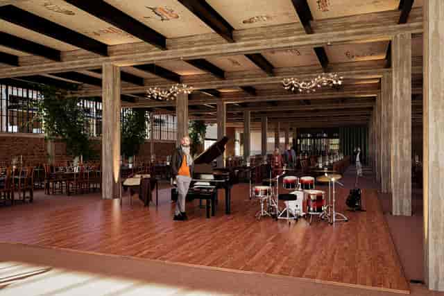 El Telar industrial venue with stage for gala and corporate event hosting.