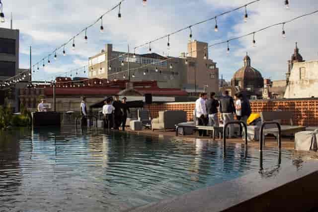 Networking reception at Antisocial Rooftop featuring a modern infinity pool and skyline view.