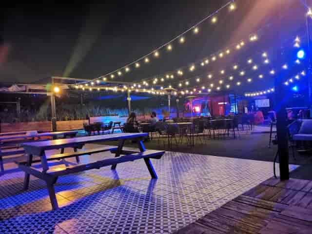 Antisocial Rooftop evening mixer venue with string lighting for networking events.