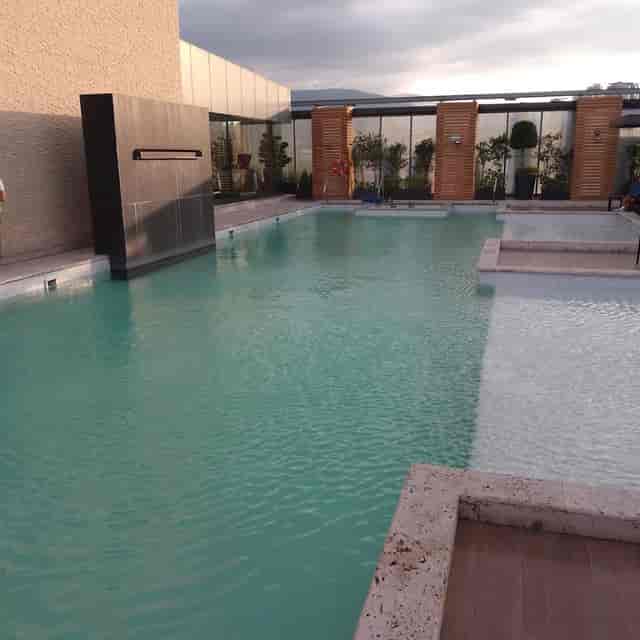Upscale multi-level rooftop pool lounge for corporate incentive trips and networking events.